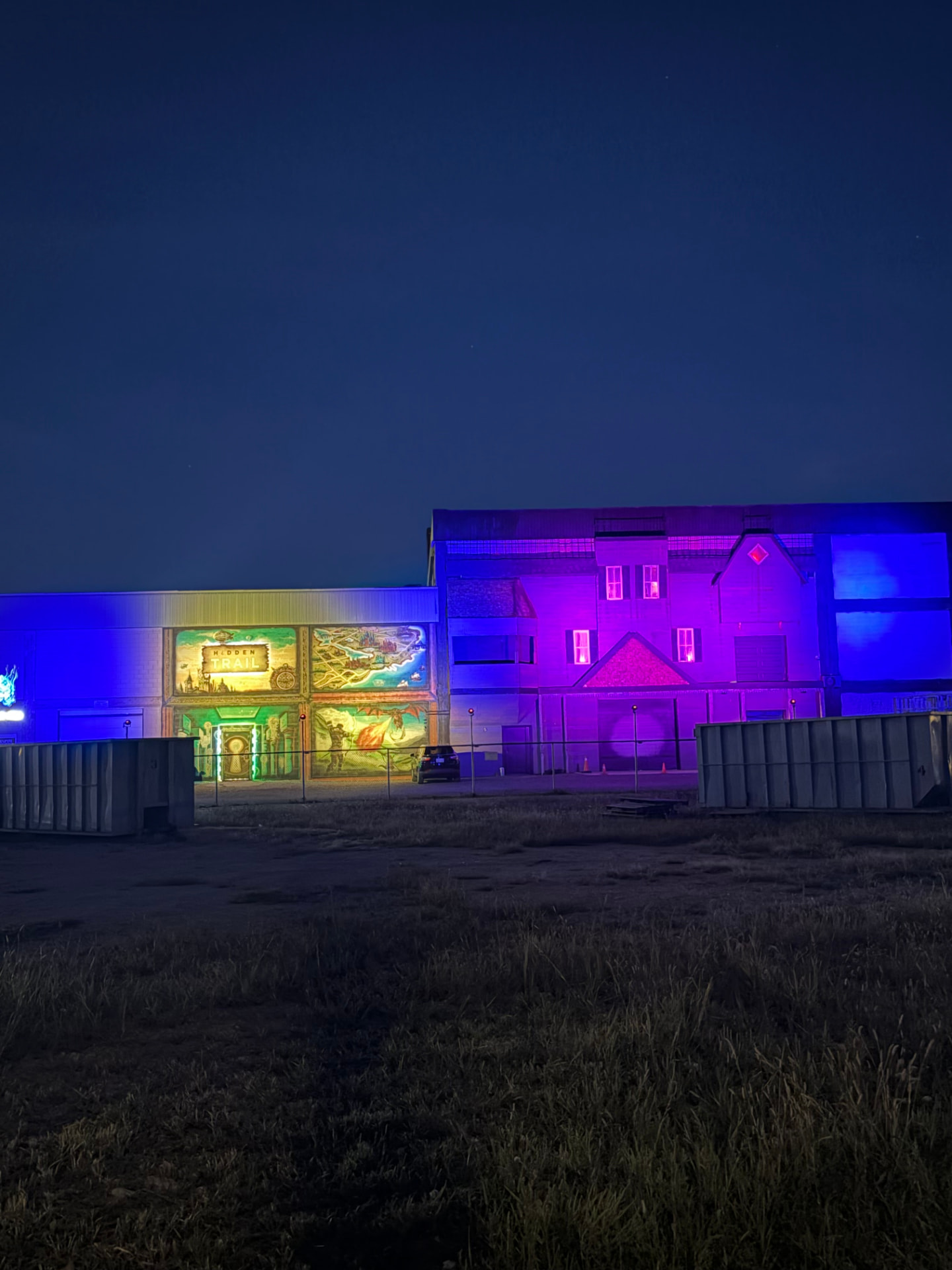 Wide nighttime view of ScareHouse Windsor and its illuminated exterior